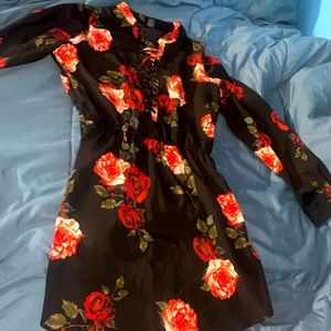 I’m selling a medium size Rue 21 black dress with red roses
